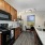 kitchen with granite countertops, sink, microwave, and stove