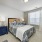 Apartment bedroom with furniture and large window