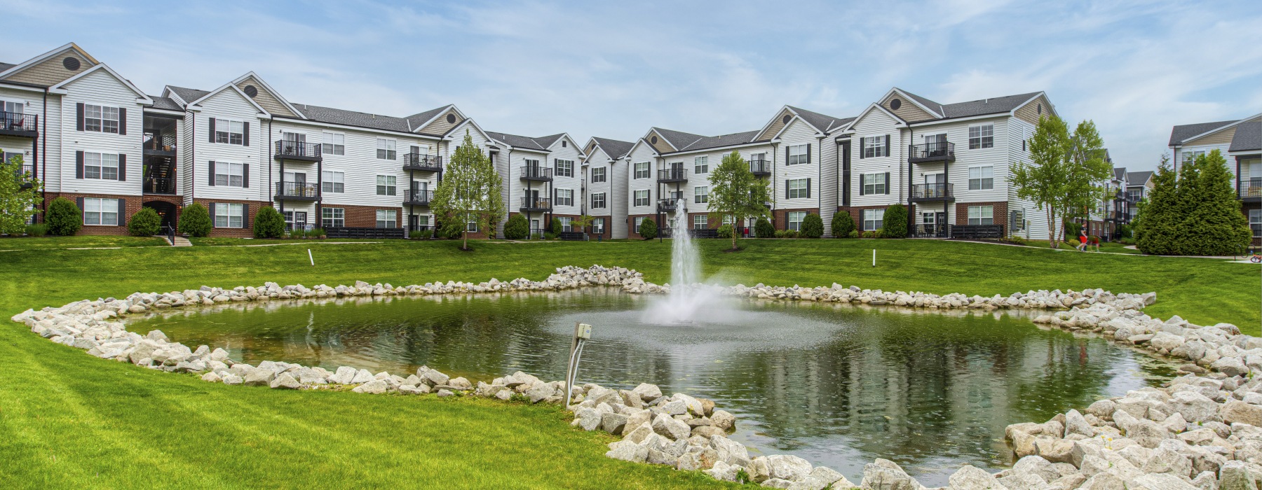 Apartment building exterior with a pond